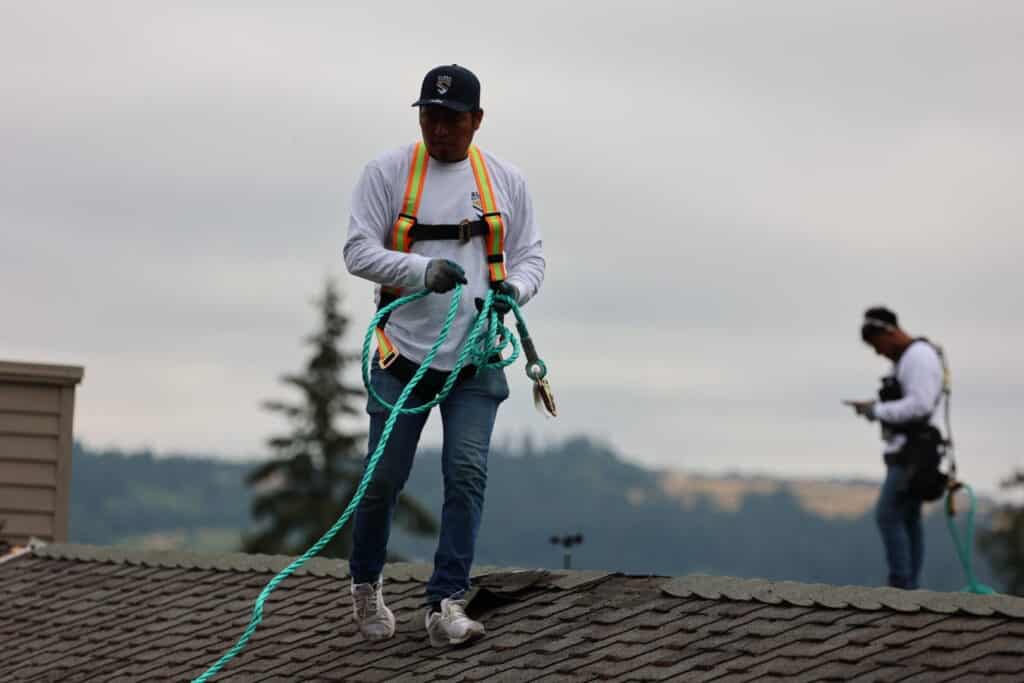 Worker on roof in safety gear