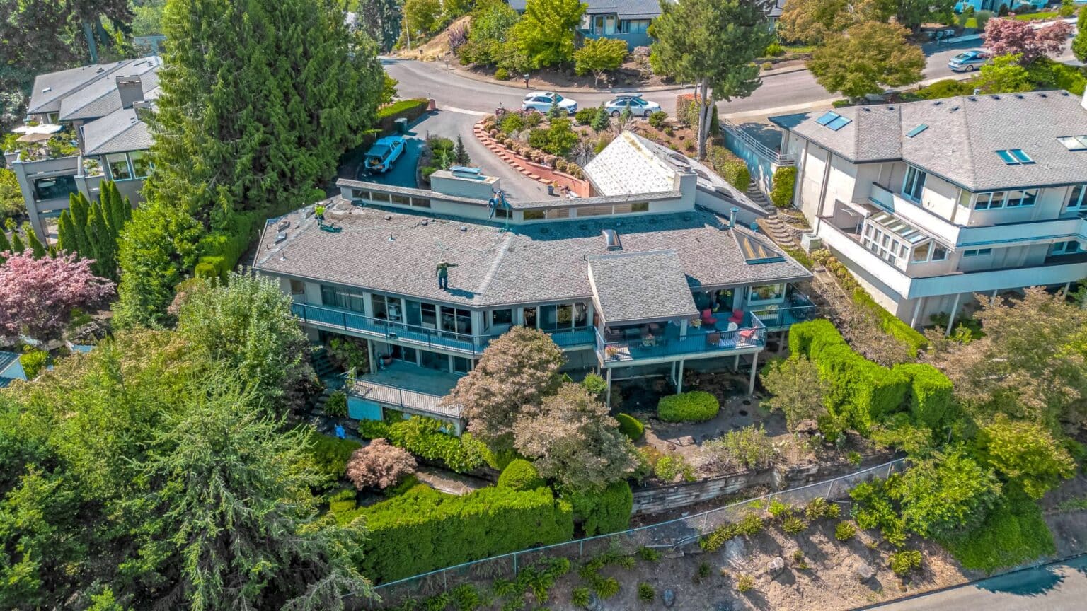 Drone view of beautiful home with new roof in Cherokee