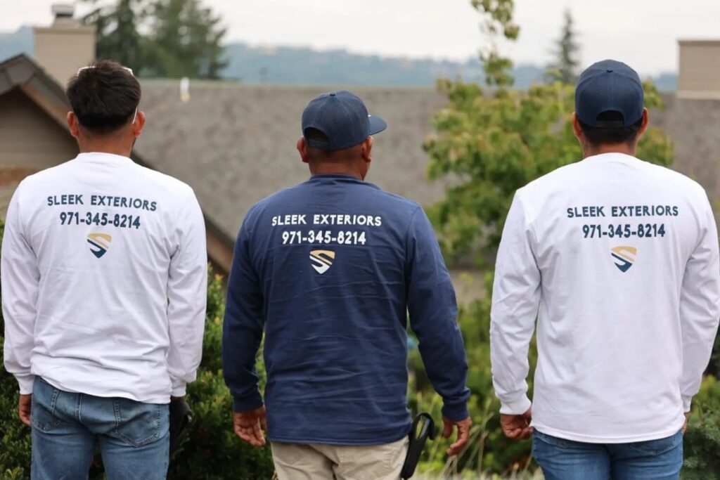 Three Sleek Exteriors workers wearing Sleek Exteriors t-shirts walking from behind